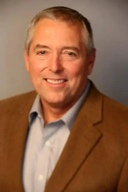 Portrait of Pastor Jay Shirley smiling, wearing a brown jacket