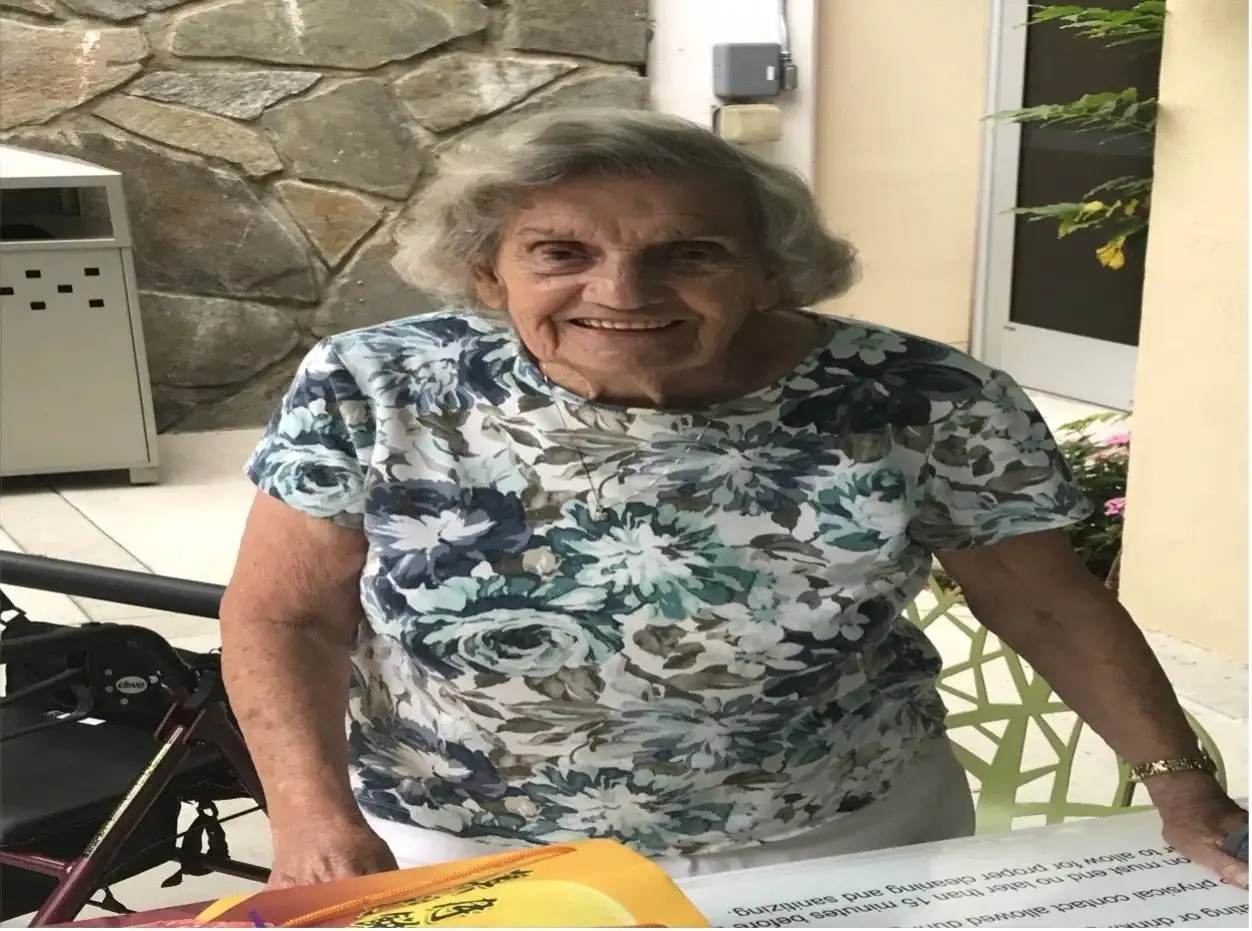 A longtime member smiling warmly on the church patio