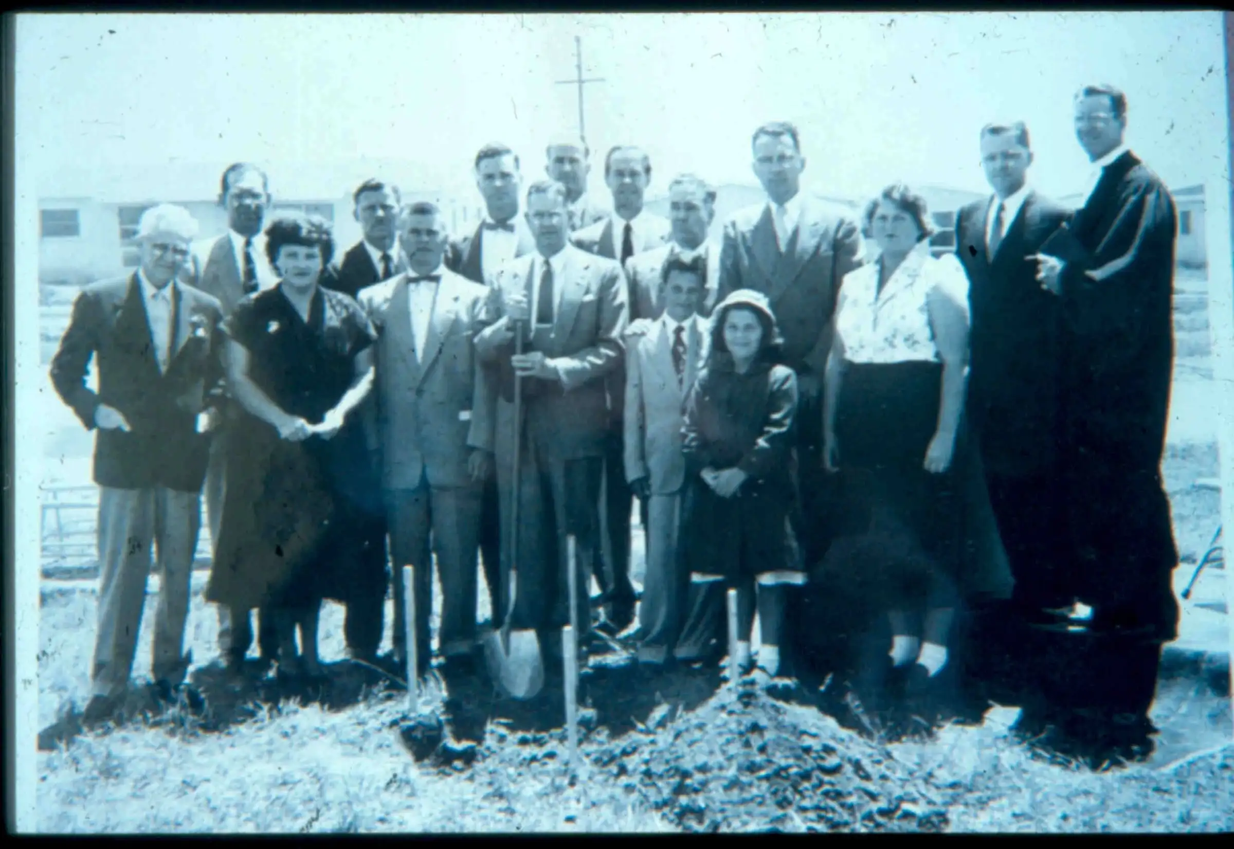 Black-and-white photo of the founding congregation gathered with shovels at the ground breaking