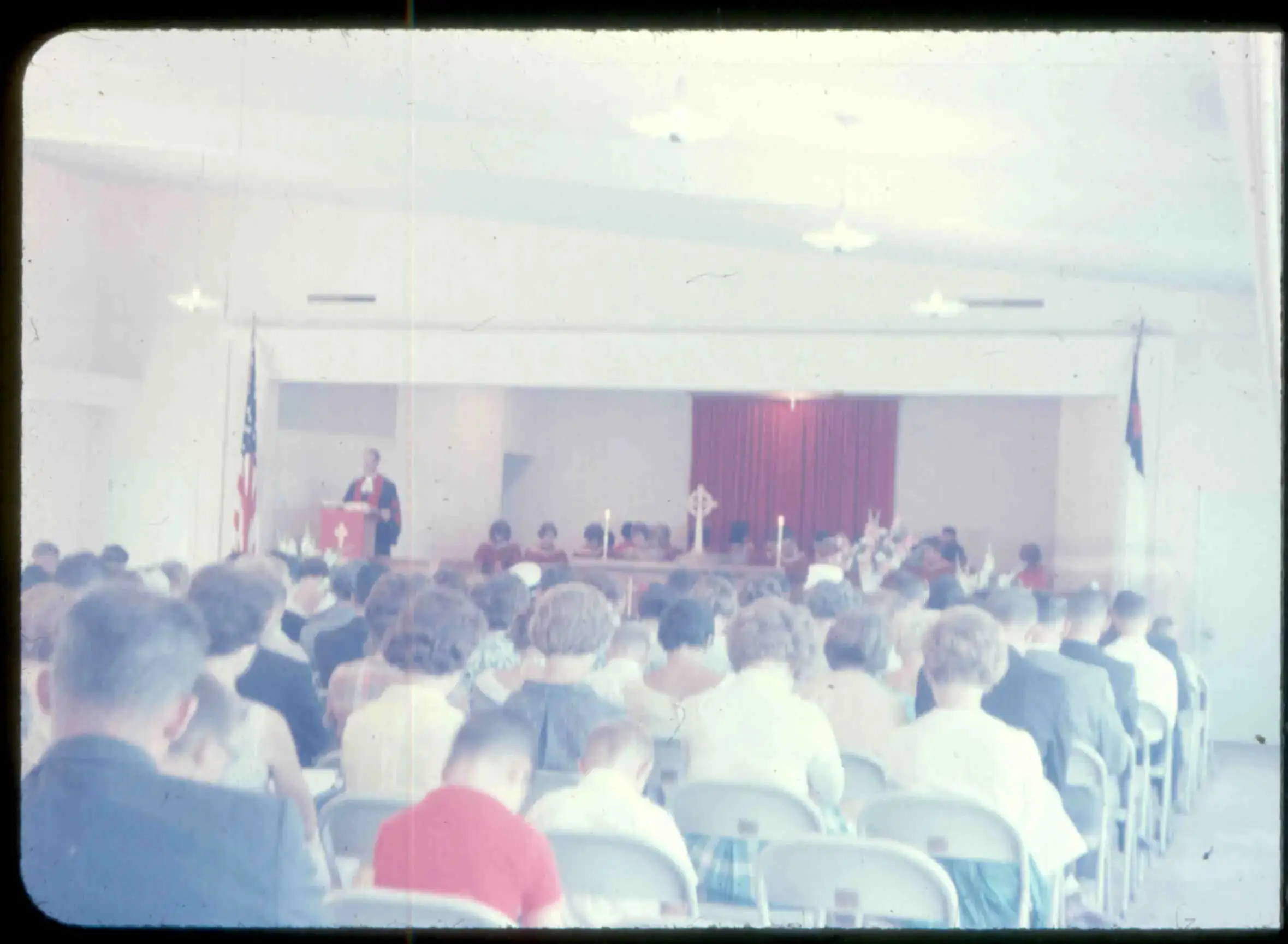Worshipers seated in rows inside Fellowship Hall