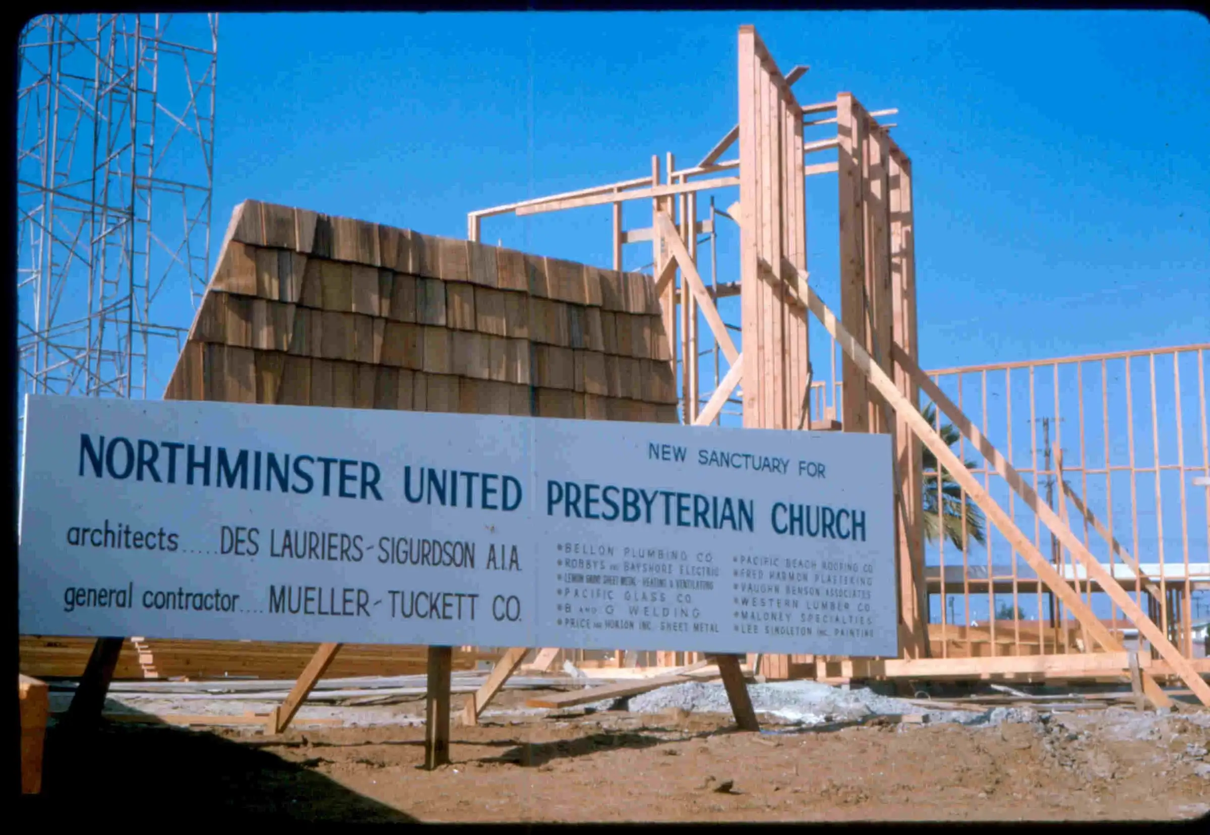 A “Northminster United Presbyterian Church” construction sign in front of the wooden sanctuary frame